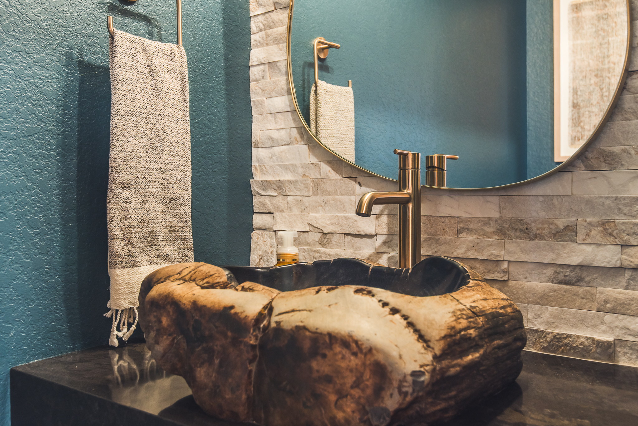 bathroom with sink made from chunk of petrified wood