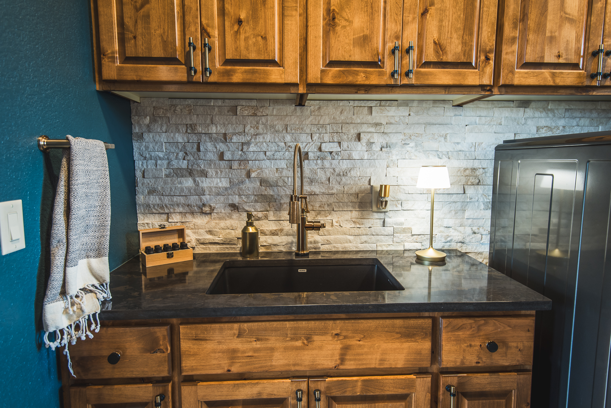 sink area with wood cabinets